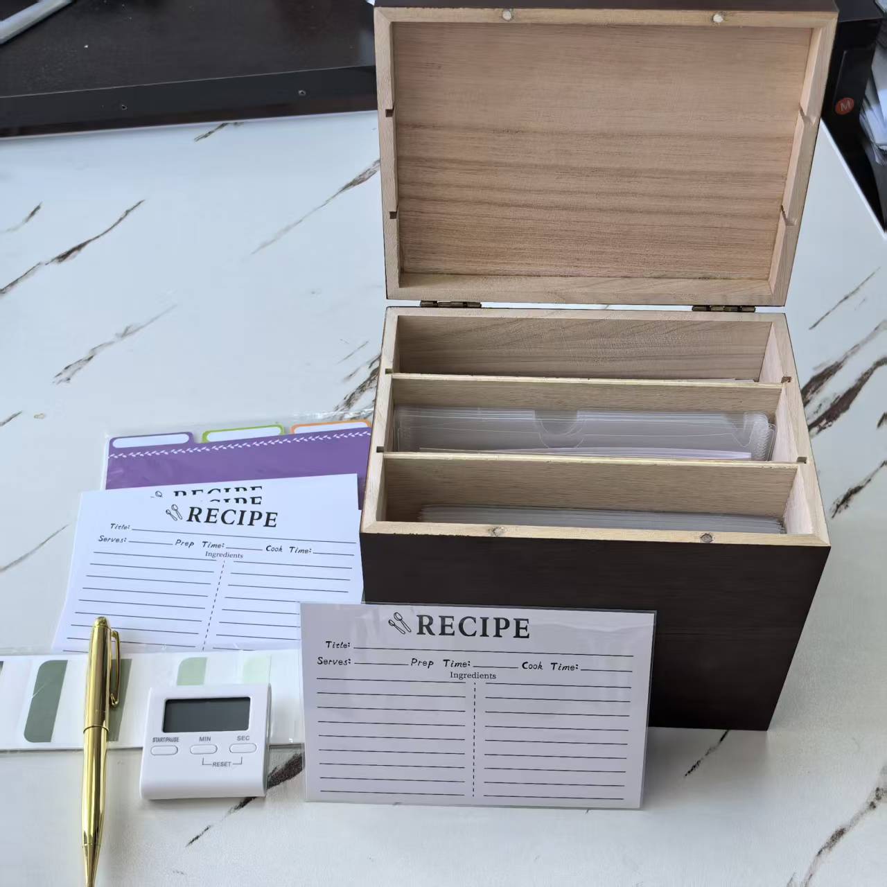 Wooden recipe box set with internal dividers, recipe cards and supporting accessories.