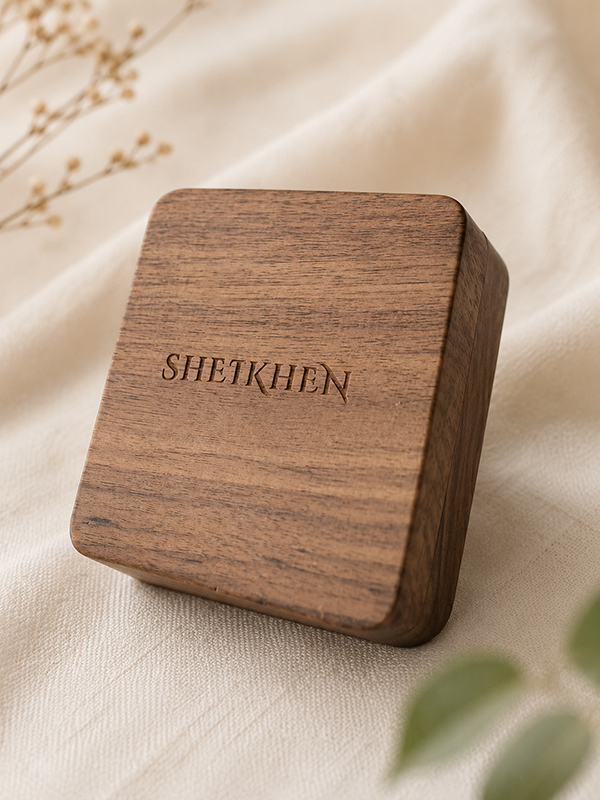 Walnut double ring box with a laser-engraved design on its inner lid.