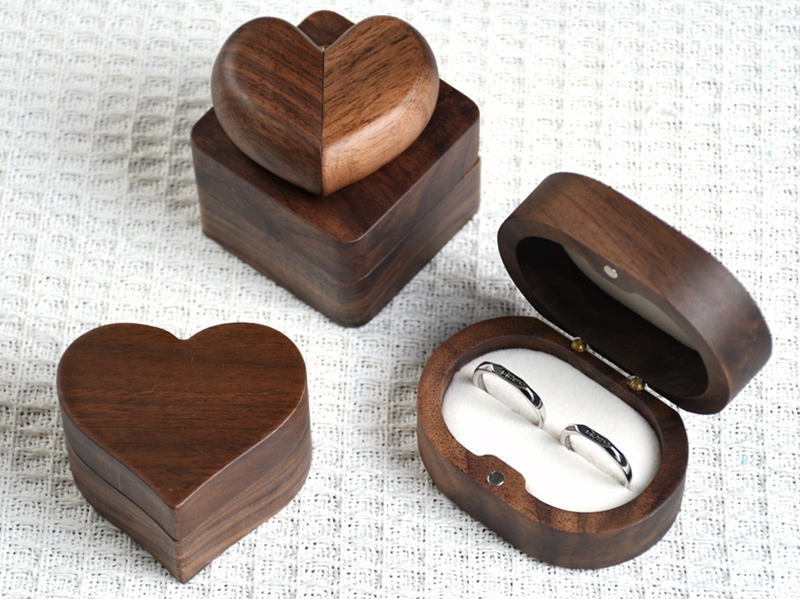 Walnut Ring Box custom development direction Walnut ring boxes in heart and oval formats, showing natural grain and velvet-lined presentation.